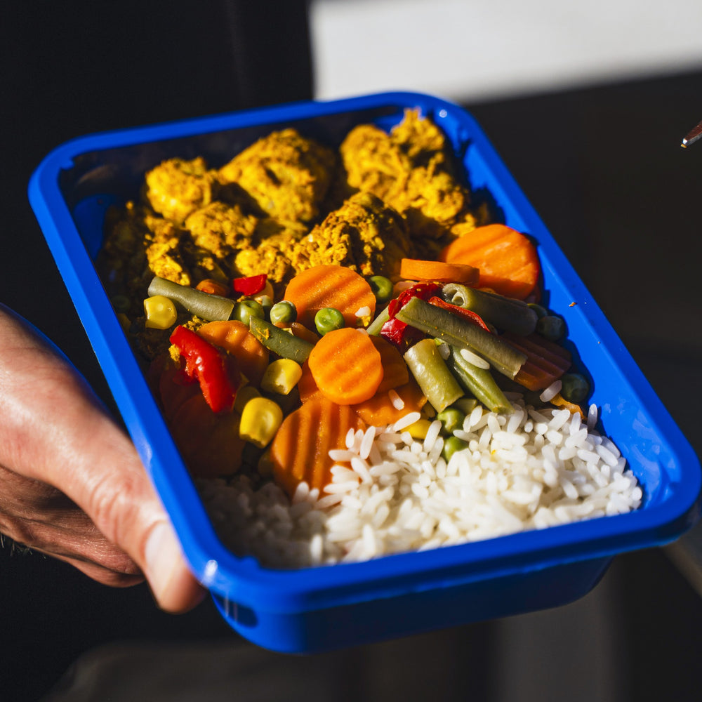 Open SportMeals box on the kitchen counter with the meals in the silver insulated bag