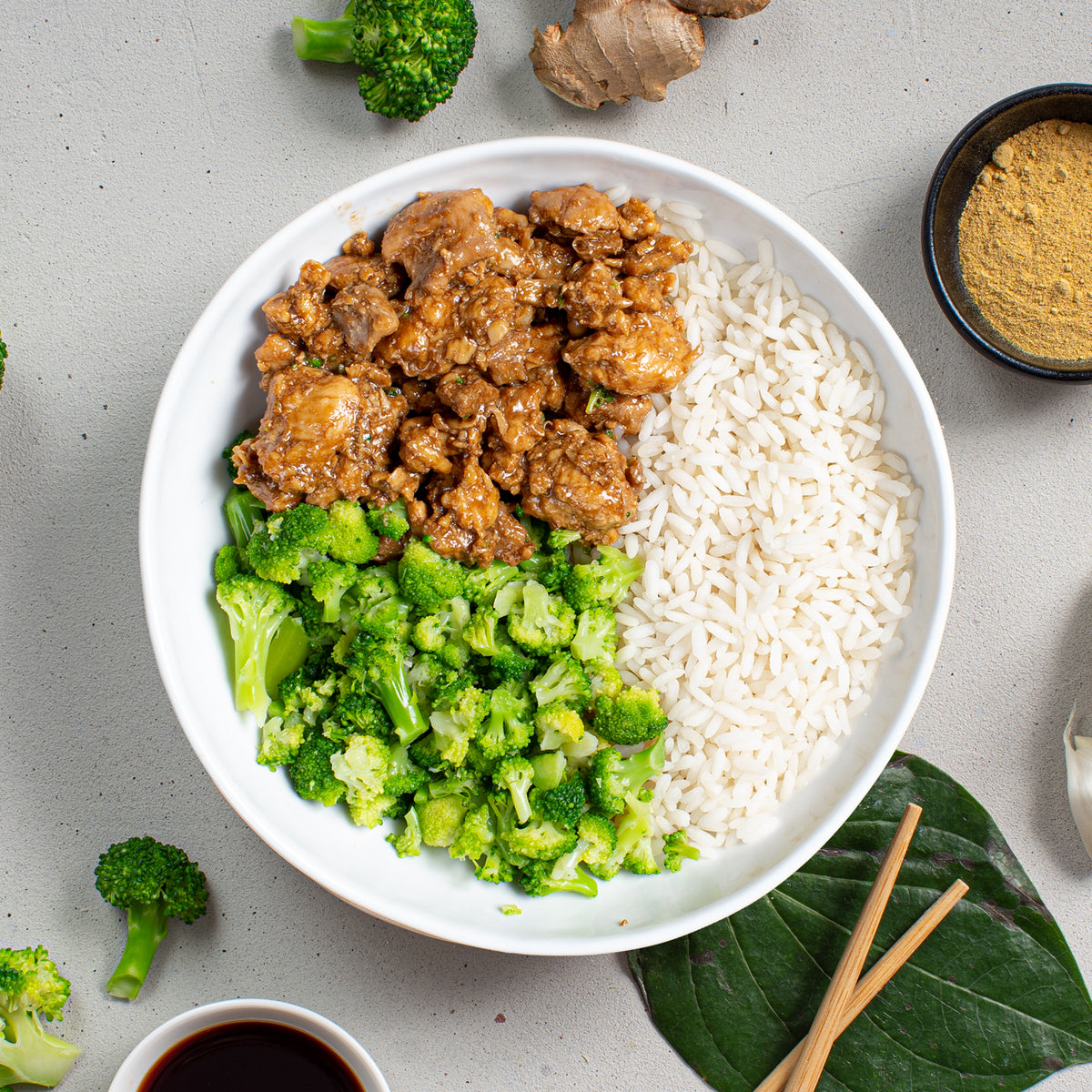 SportMeals Chicken Teriyaki with rice and broccoli, served on a plate